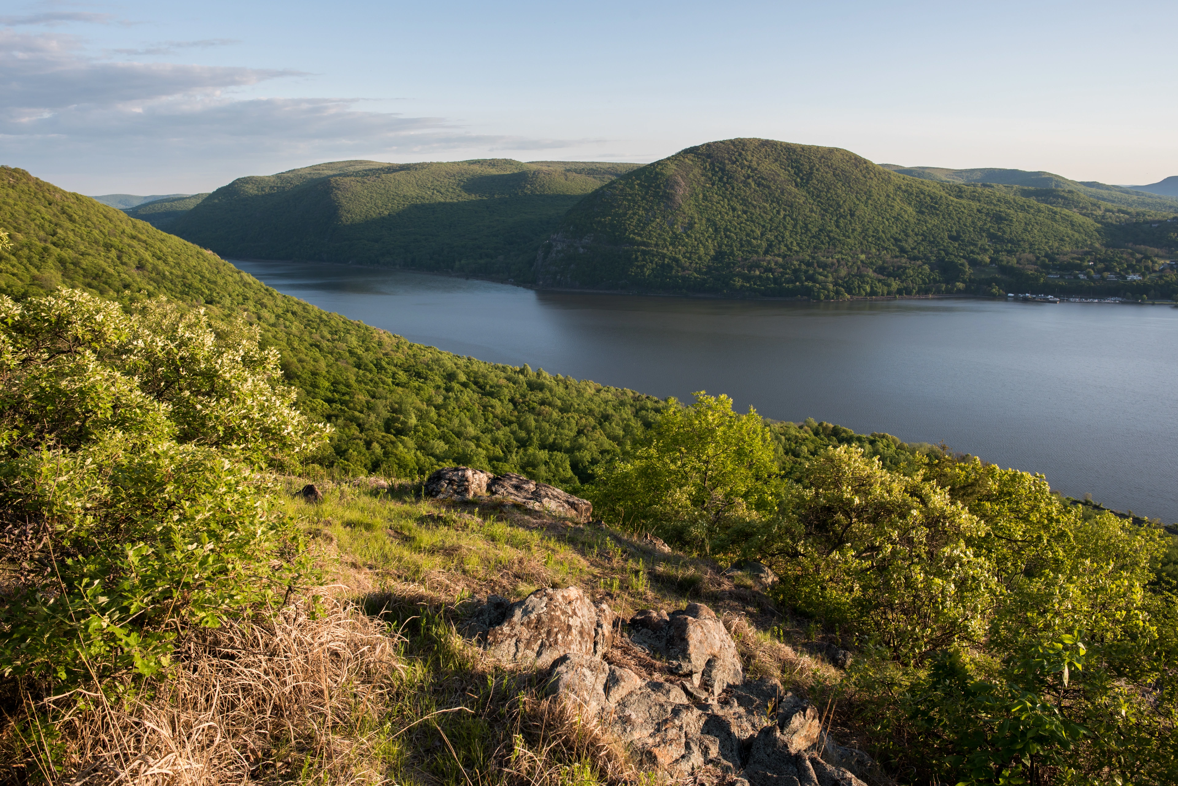 Sunlit green Hudson Highlands and the Hudson River viewed from Sugarloaf Mountain